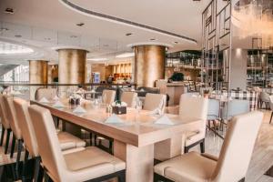 a dining room with a long table and chairs at Ramada Plaza Pudong Shanghai in Shanghai