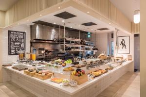 a buffet line with many different types of food at amba Taipei Zhongshan in Taipei