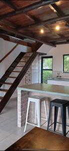 a kitchen with a table and two stools at Picturesque 82 in Buffelspoort