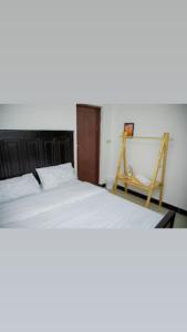 a bedroom with two beds and a ladder in it at La casa Cottage in Iringa