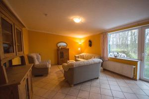a living room with a couch and a window at Im Obsthaus 9 in Göhl