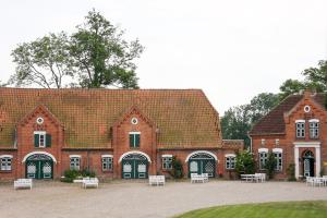 a large brick building with white chairs in front of it at Im Obsthaus 9 in Göhl