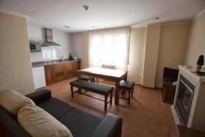 a living room with a couch and a table at Apartamentos Don Clemente in Las Rozas