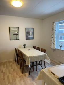 a dining room with a white table and chairs at Motel Viborg in Viborg