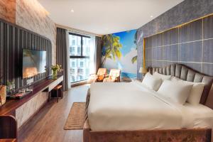 a bedroom with a large bed and a tv at Apec Mandala Chambay Mui Ne - Oceanic Studio in Mui Ne