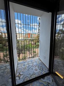 a glass door with a view of a balcony at Moscatel - Harbor's Light in Villajoyosa