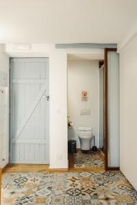 a bathroom with a white door and a toilet at Moscatel - Harbor's Light in Villajoyosa +12 photos