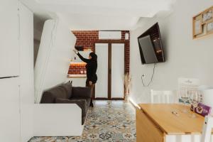 a woman standing at the door of a living room at Moscatel - Harbor's Light in Villajoyosa