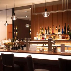 a bar with a lot of bottles of alcohol at Bernstein Landhaus Nordhelle in Meinerzhagen