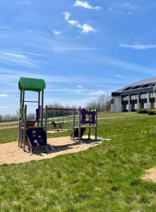 a park with a playground with two swings at Bernstein Landhaus Nordhelle in Meinerzhagen