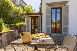 a table with a vase on it on a patio at Lo Studiolo Fiesole in Fiesole +31 photos