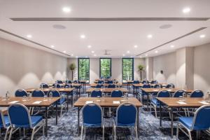 a conference room with tables and chairs and windows at Ambassadori Goderdzi Hotel in Goderdzi +160 photos