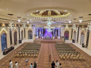 a large banquet hall with a stage in the middle at Ummaid palace, Siwan in Siwān