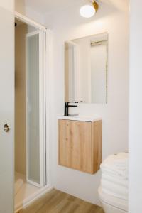 a bathroom with a sink and a mirror at Verdejo - Harbor's Light in Villajoyosa +11 photos