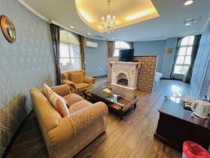 a living room with a couch and a fireplace at Huis Ten Bosch in Ren'ai