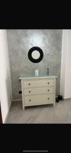 a dresser with a mirror on top of it at Siracusa Vacanze in Syracuse +72 photos