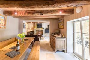 a living room with a wooden table and a couch at Le P'tit Clos in Vantoux