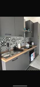 a kitchen with a sink and a counter top at Siracusa Vacanze in Syracuse