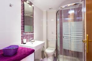 a bathroom with a toilet and a sink and a shower at Eleonas Apartments in Prinés +51 photos