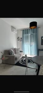 a living room with a couch and a table at Siracusa Vacanze in Syracuse