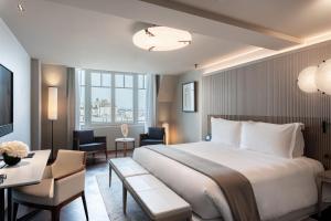 a hotel room with a large bed and a desk at Mandarin Oriental Lutetia, Paris in Paris