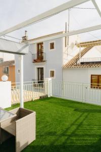 a balcony with green grass and a white house at Cabernet Sauvignon - Harbor's Light in Villajoyosa