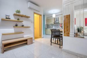 a kitchen and dining room with a yellow door at 1-Bed Suite Near Spinola Bay in Paceville