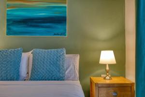 a bedroom with a bed with a lamp on a night stand at 1-Bed Suite Near Spinola Bay in Paceville