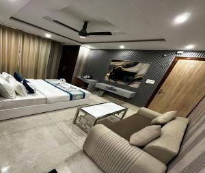 a living room with a bed and a couch at Minta Hotel and Banquet in Noida