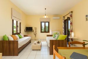 a living room with a couch and a table at Eleonas Apartments in Prinés