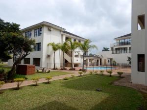 an exterior view of a building with a yard at The Shores, Ramsgate in Ramsgate