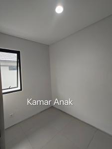 a living room with a window and white walls at Park Serpong Type XYZ Cluster Charm in Carangpulang