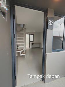 a sliding glass door leading to a hallway with stairs at Park Serpong Type XYZ Cluster Charm in Carangpulang