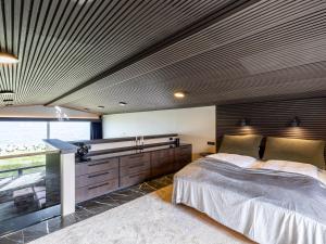 a bedroom with a large bed and a wooden ceiling at Bay View Villa in Gardur +22 photos