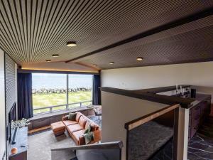 a living room with a couch and a fireplace at Bay View Villa in Gardur