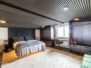 a bedroom with a bed and a desk at Bay View Villa in Gardur