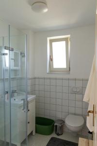 a bathroom with a sink toilet and a window at Haptapta House in Balatonudvari +19 photos
