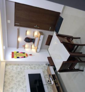 an overhead view of a room with stairs and a mirror at Vaiga Heavens - 1 BHK Apartment, 500 m to temple in Guruvāyūr
