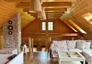 a living room with a couch and a fireplace at Rusínsky Dvor s privátnym Wellness in Malý Lipník