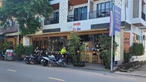 a group of motorcycles parked in front of a store at Park Inn Boutique and Hostel in Kampot
