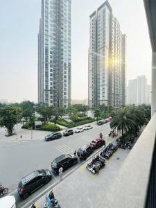 a parking lot with cars parked in front of tall buildings at Studio Ocean Park 0301 - toà S1 in Gia Lâm Pho