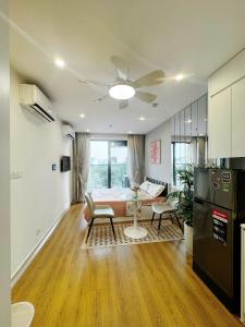 a living room with a bed and a kitchen at Studio Ocean Park 0301 - toà S1 in Gia Lâm Pho
