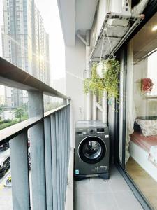 a washing machine on a balcony in a building at Studio Ocean Park 0301 - toà S1 in Gia Lâm Pho