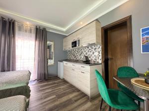 a kitchen with a table and chairs in a room at Villa Sun Budva in Budva