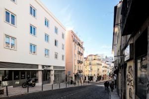 a city street with buildings and people walking down a street at LSA Restauradores by Numa in Lisbon +41 photos