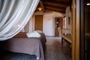 a bedroom with a bed and a table in a room at Antica Dimora Palinuro in Palinuro +50 photos