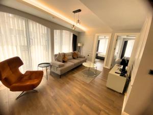 a living room with a couch and a chair at Myway Deluxe Hotel in Konak