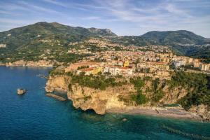 an aerial view of a village on a cliff over the water at Hotiday Vico Equense in Vico Equense