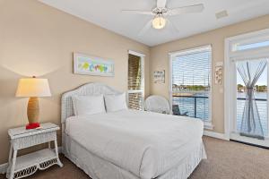 a bedroom with a white bed and a window at Destiny Beach Villas #9A in Destin +34 photos