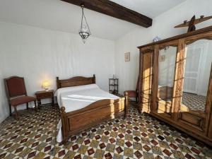 a bedroom with a bed and a table and a chair at Maison jeanborde in Serreslous-et-Arribans